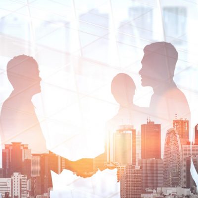 Double exposure image of many business people conference group meeting on city office building in background showing partnership success of business deal. Concept of teamwork, trust and agreement.